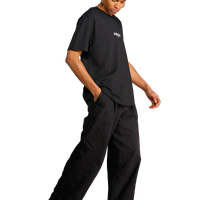 T-shirt nera con stampa sul retro di satiri che ballano indossata dal modello vista di lato.